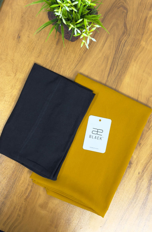Golden mustard hijab with a classic black cap for effortless styling.