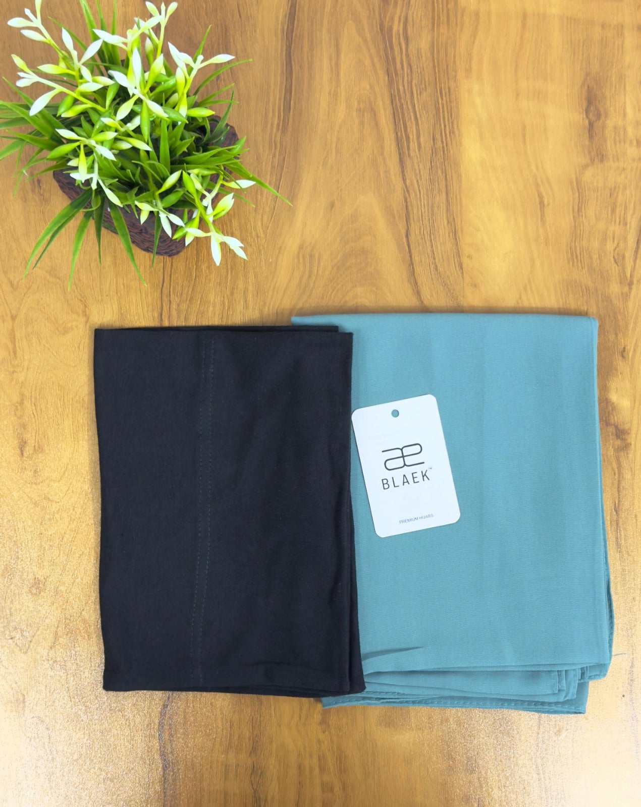 Refreshing mint hijab with a structured black cap.