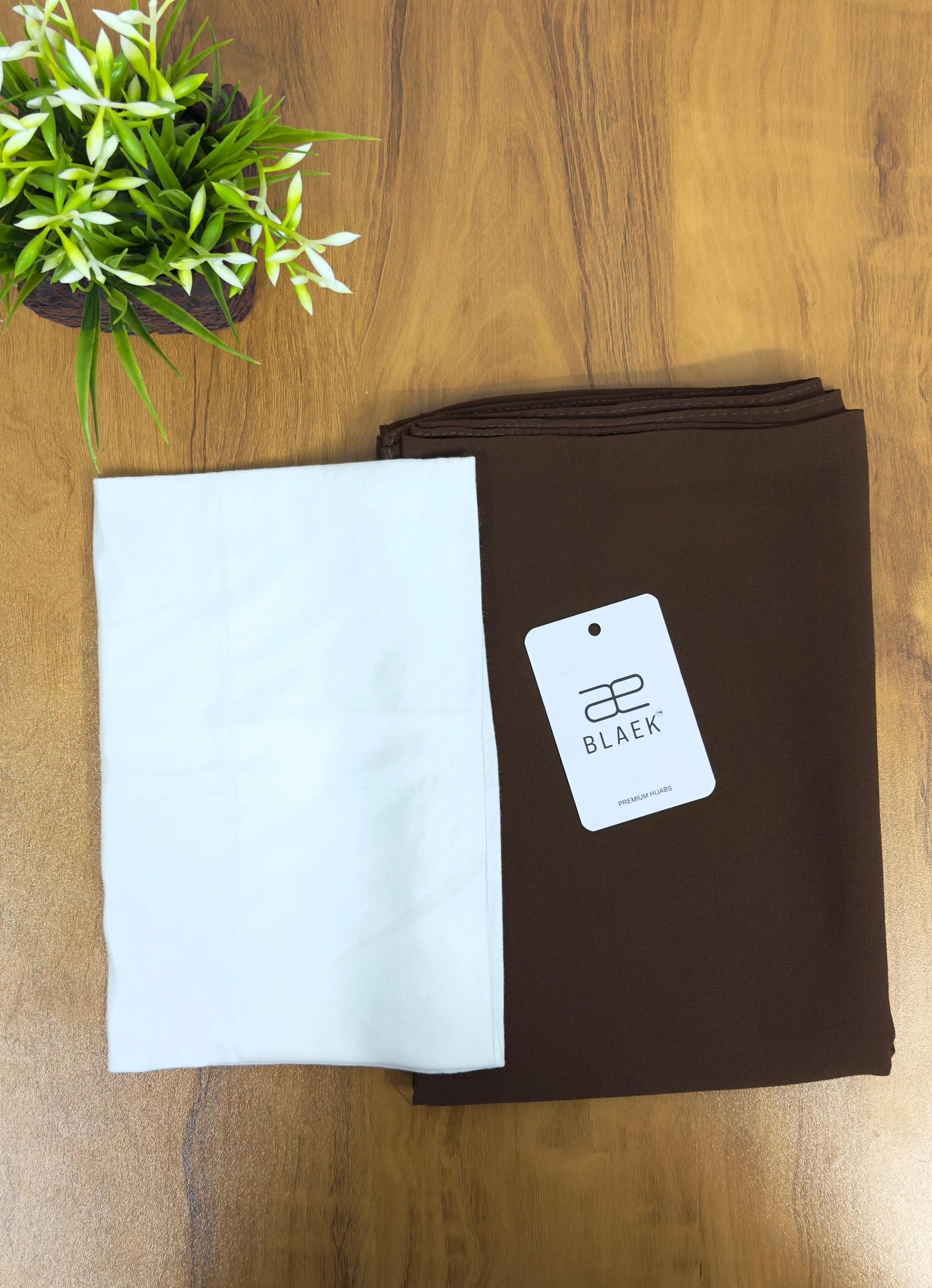 Neatly folded mocha hijab with crisp white cap, slider mag design.