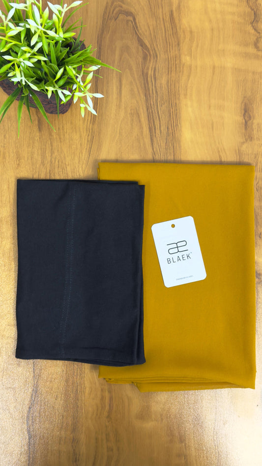Mustard-toned slider hijab with black cap, compact display.