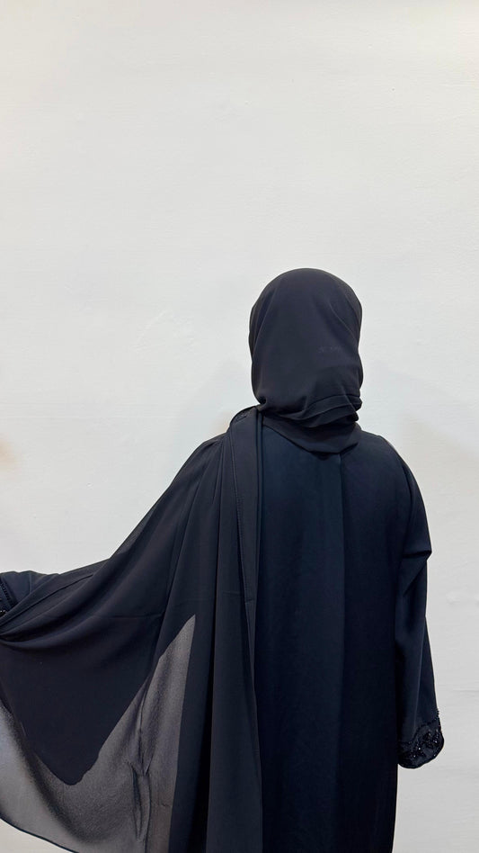 Black hijab with a sleek, timeless look, styled with elegance and simplicity.