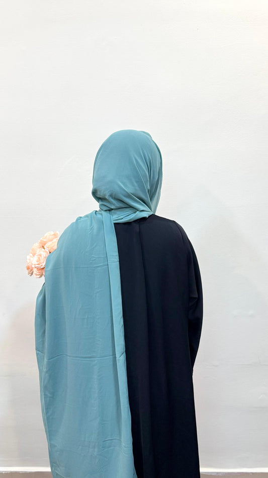 Mint green hijab with a cool cyan undertone, giving a fresh, airy, and modern vibe.