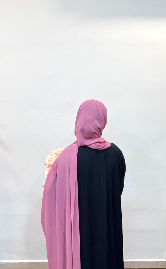 Close-up of a puce pink hijab, showing off its muted rose tone and soft fabric texture.