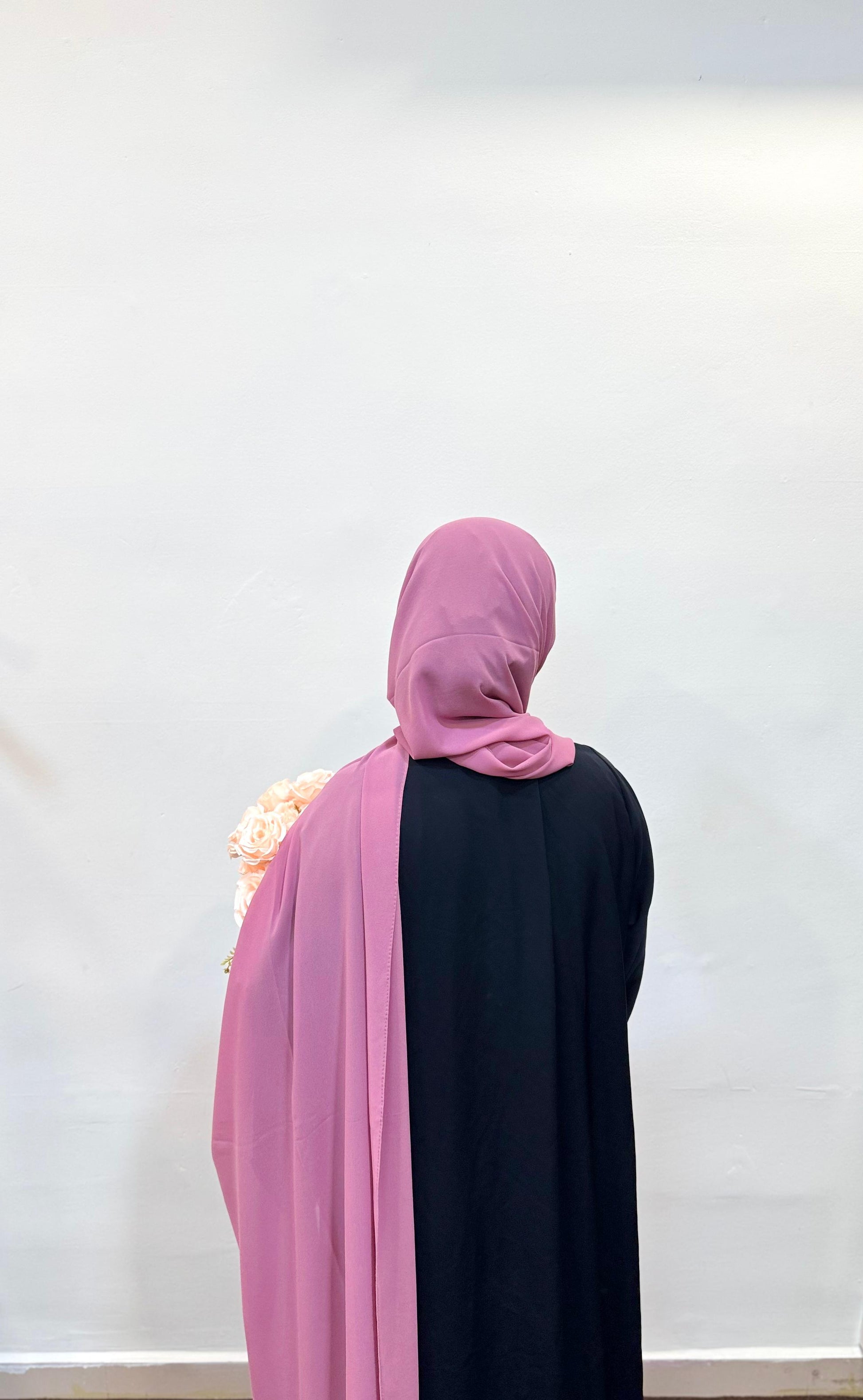 Close-up of a puce pink hijab, showing off its muted rose tone and soft fabric texture.