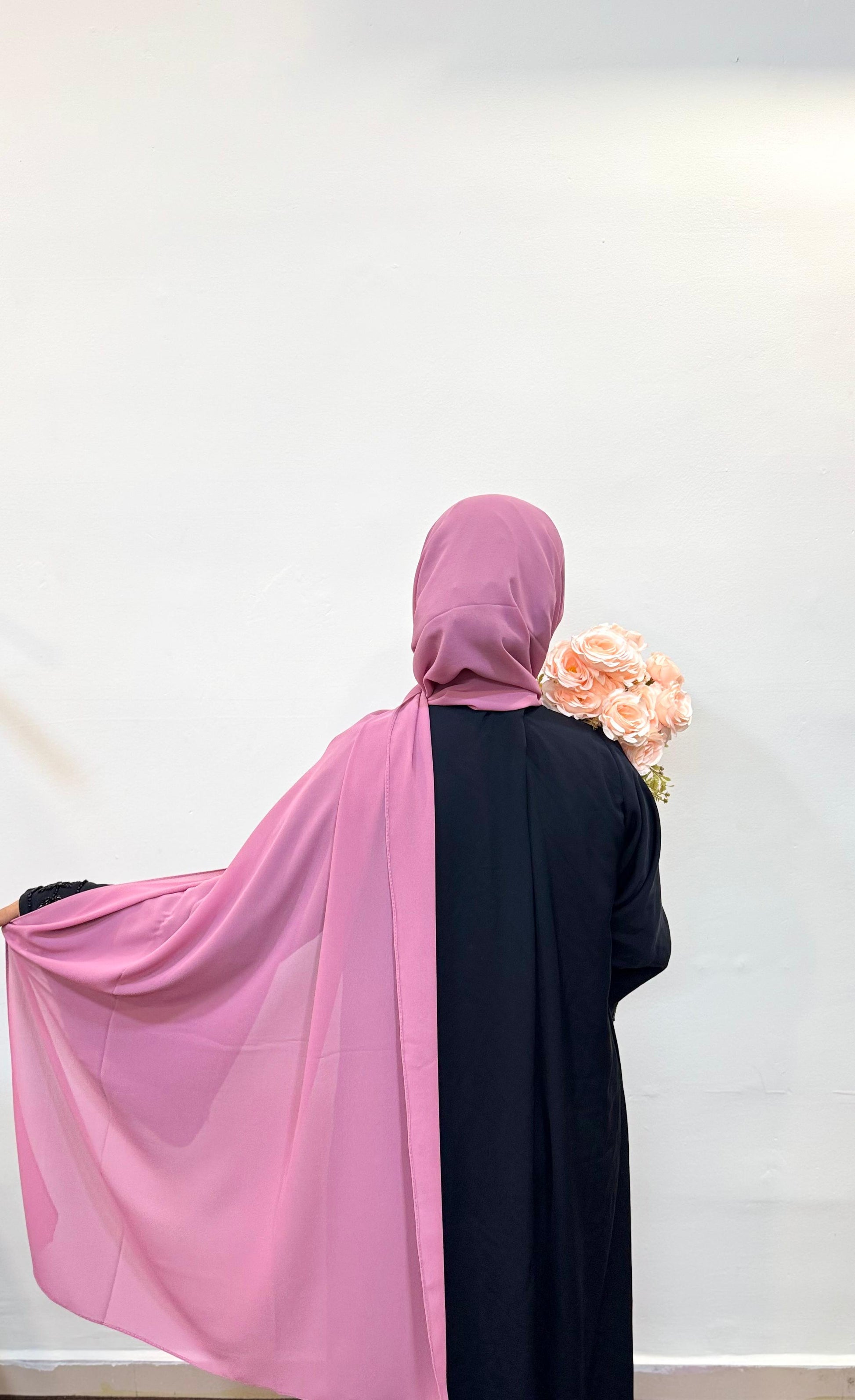 Close-up of a puce pink hijab, showing off its muted rose tone and soft fabric texture.