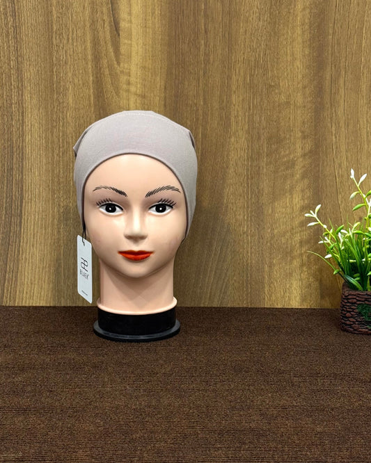 Mannequin showcasing a dust storm-colored tube cap, front angle.