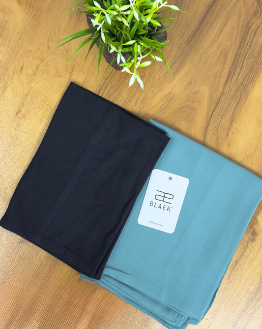 Mint green hijab with black cap, slider mag style, folded.