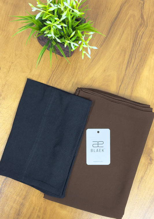 Neatly folded slider hijab in mocha shade with black cap.